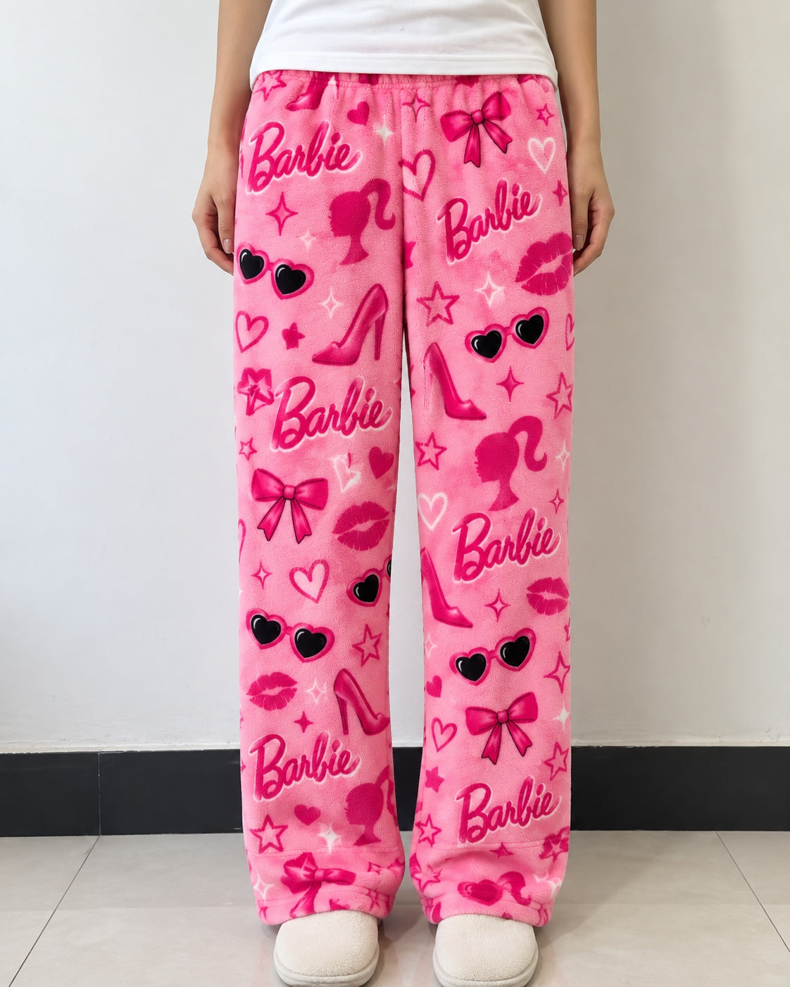 Pink Barbie print fleece lounge pants worn